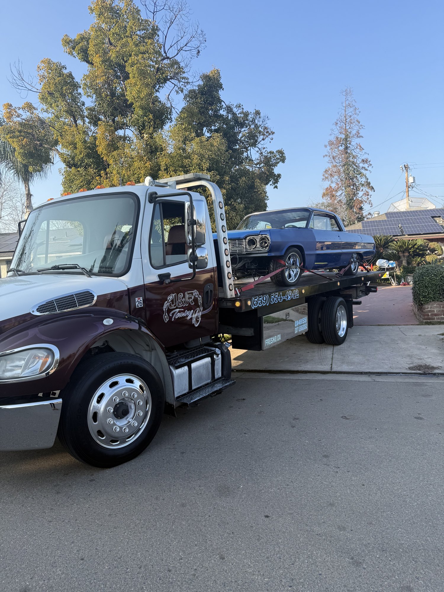 J&R Towing transporting a classic car on a flatbed