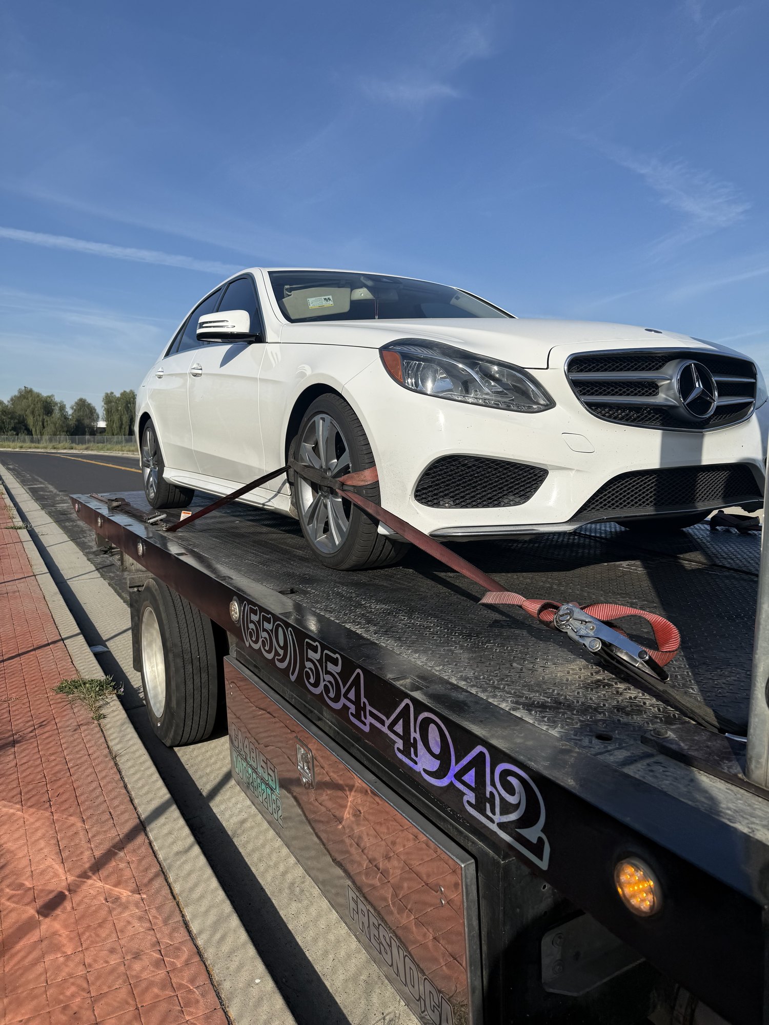 Luxury sedan secured on a J&R Towing flatbed